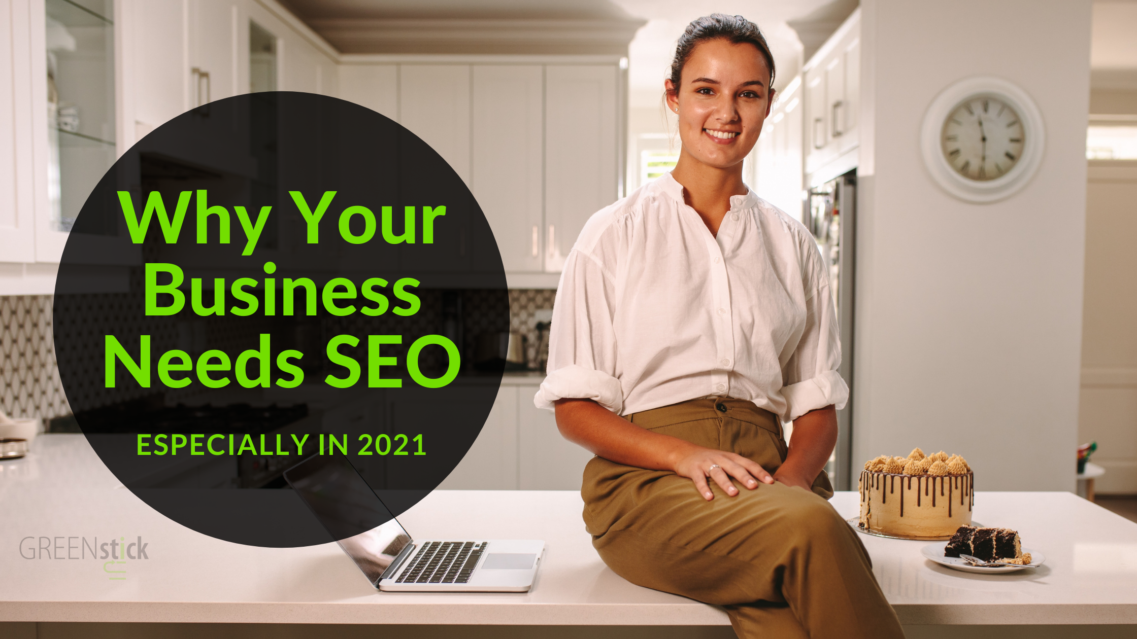 A Female Leasing Consultant inside a model apartment home sits on a kitchen countertop smiling